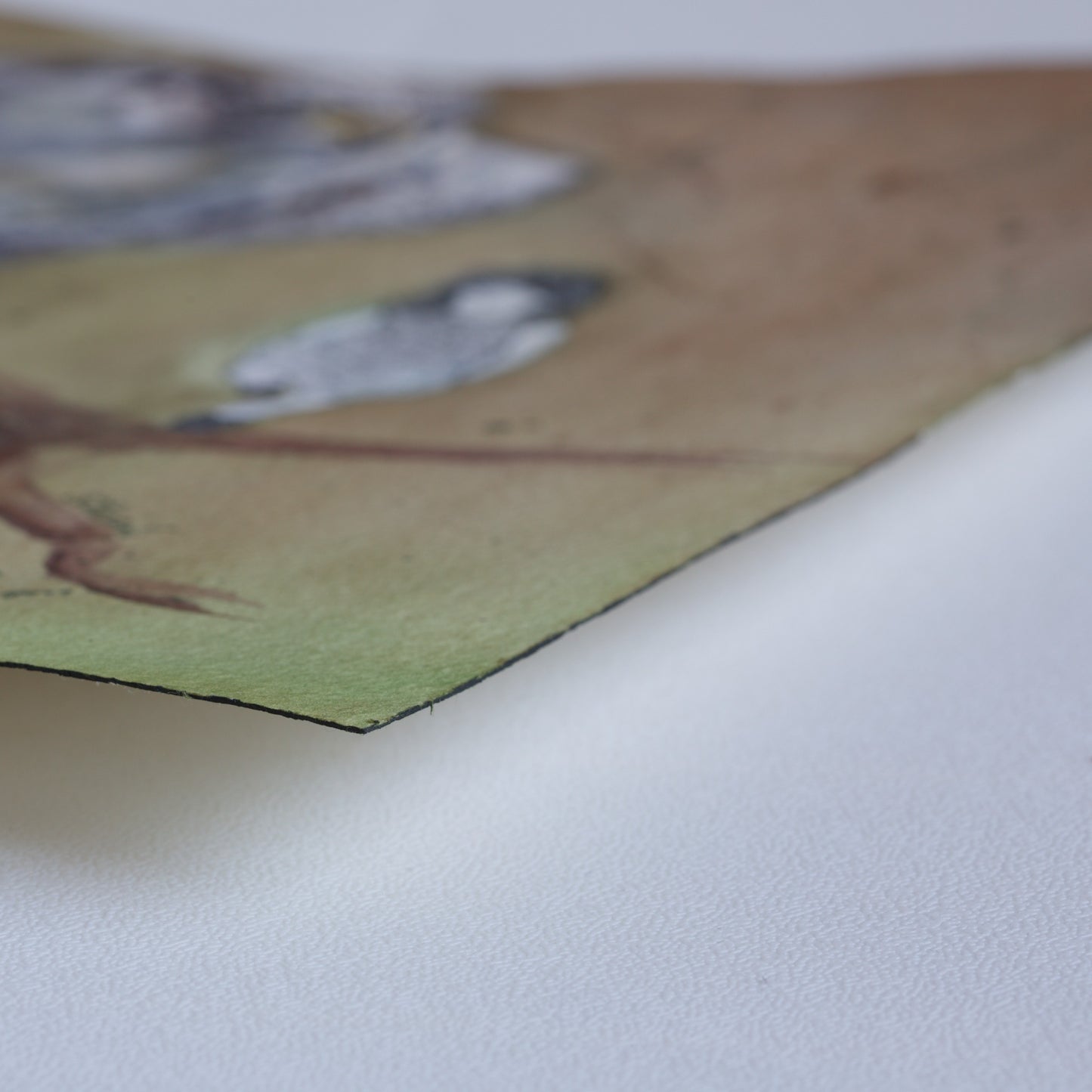 Corner detail of the original watercolor painting Branch Dance by Silvana Varriale of VARsee Art, slightly lifted from a flat surface, showing the thickness and texture of professional Arches 100% cotton watercolor paper with its characteristic black edge binding.