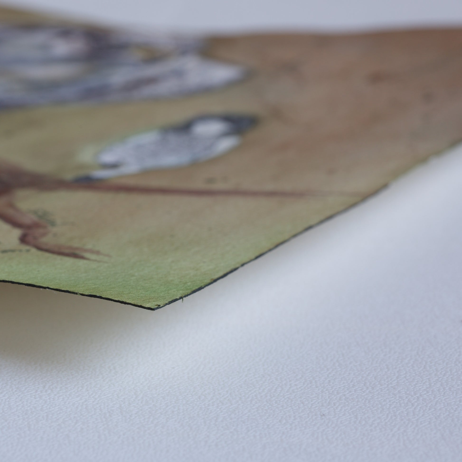 Corner detail of the original watercolor painting Branch Dance by Silvana Varriale of VARsee Art, slightly lifted from a flat surface, showing the thickness and texture of professional Arches 100% cotton watercolor paper with its characteristic black edge binding.