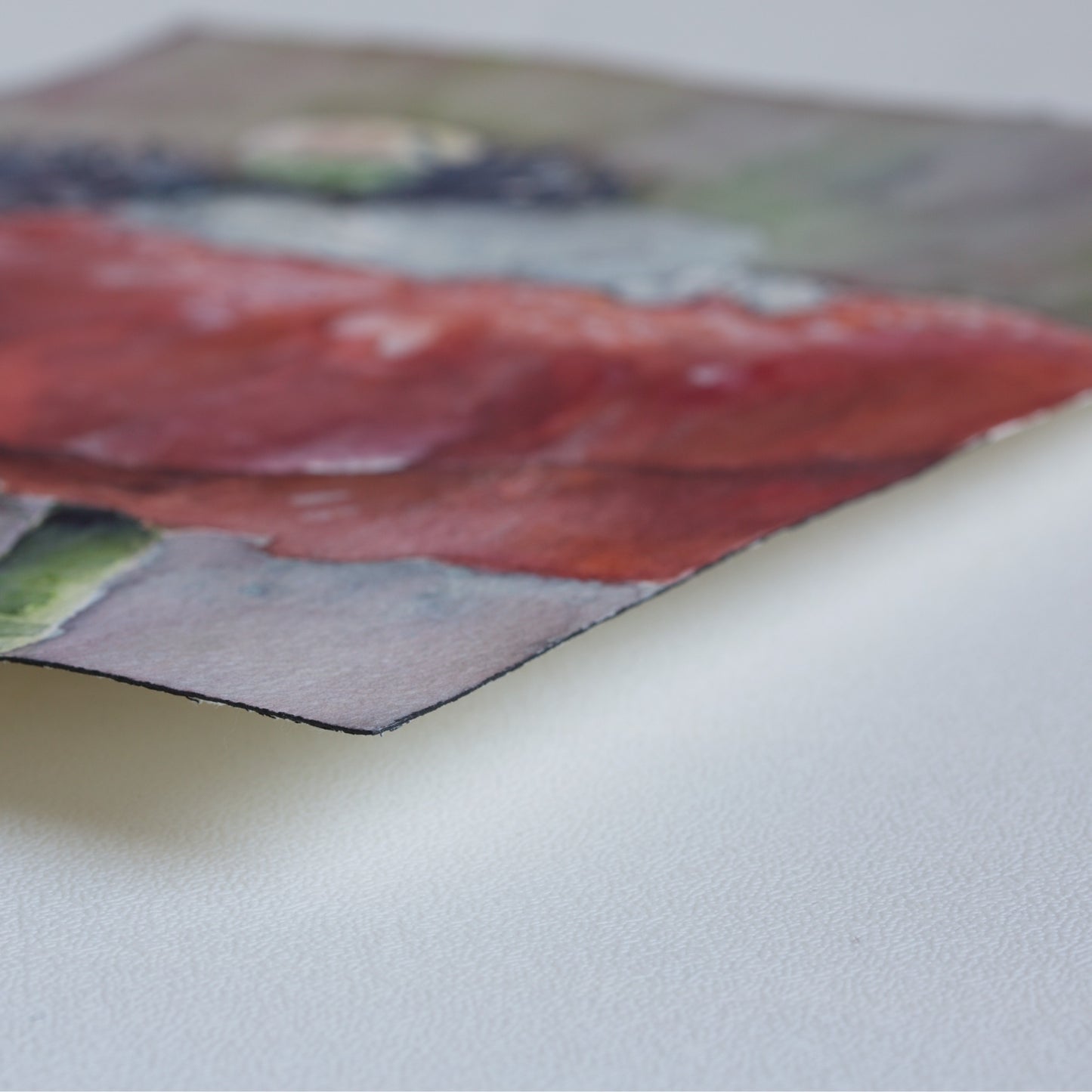 Corner detail of the original watercolor painting Flowerbed by Silvana Varriale of VARsee Art, slightly lifted from a flat surface, showing the thickness and texture of professional Arches 100% cotton watercolor paper with its characteristic black edge binding.