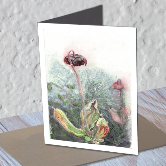 Pitcher flower watercolor greeting card standing on a kraft envelope.