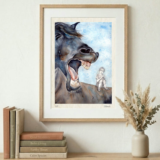 Framed Silvana Varriale watercolor giclée print showing a horse with its mouth wide open and a small figure playing the flute on his back. The frame is displayed on a wall over books and a vase on a shelf. VARsee LLC.